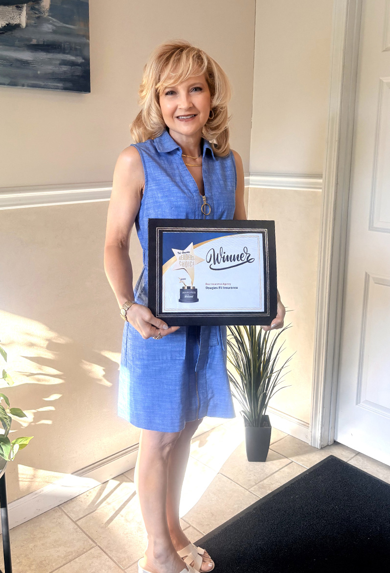 woman standing holding a framed award for the Best of Tri-County