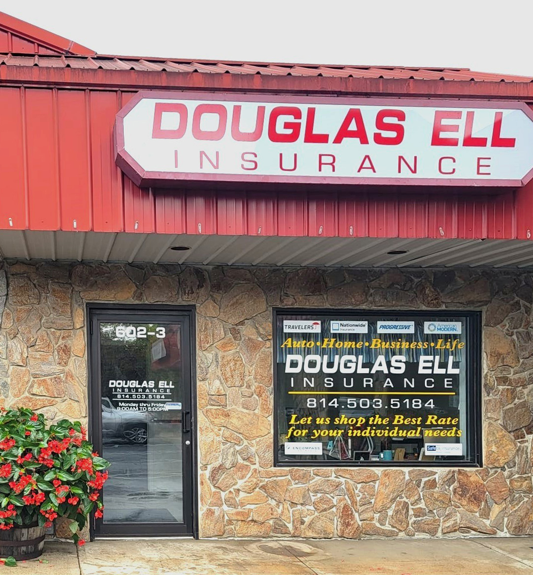 exterior photo of Douglas Ell Insurance, a stone facade with a red roof and signage